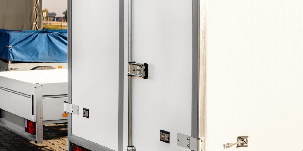 Many different types small passenger car cargo freight trailers parked in row at sale or rental site. Business and home transportation delivery. Service production and maintenance equipment.